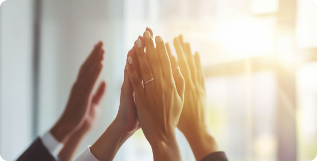 Four sets of hands high fiving